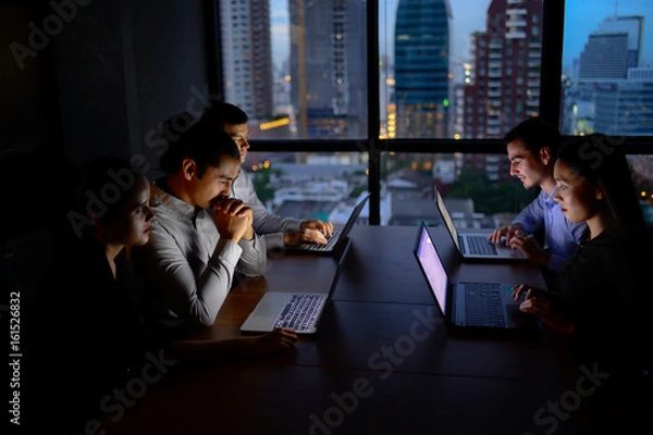 Fototapeta business team working with computer overtime at night and low light