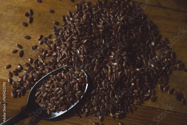 Fototapeta flax seeds on a wooden table close-up