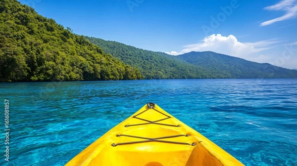 Fototapeta Brightly colored kayak floating on calm water surrounded by scenic nature and reflections