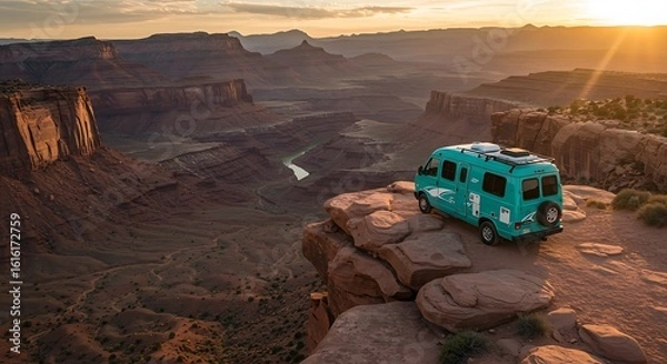 Fototapeta A teal van parked on a cliff overlooking a canyon view