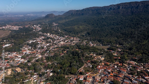 Fototapeta Aerial view of the São José mountain range, which borders the city of Tiradentes, in Minas Gerais, Brazil, on a beautiful dawn with clouds and blue sky.