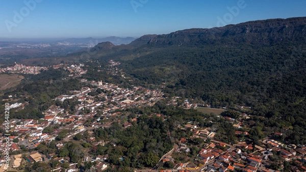 Fototapeta Aerial view of the São José mountain range, which borders the city of Tiradentes, in Minas Gerais, Brazil, on a beautiful dawn with clouds and blue sky.