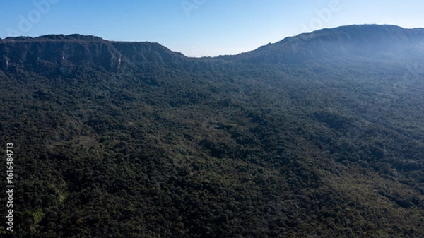 Fototapeta Aerial view of the São José mountain range, which borders the city of Tiradentes, in Minas Gerais, Brazil, on a beautiful dawn with clouds and blue sky.