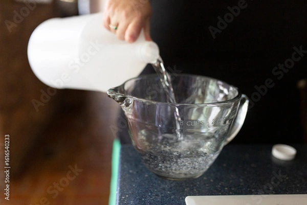 Obraz Pouring vinegar for pickling
