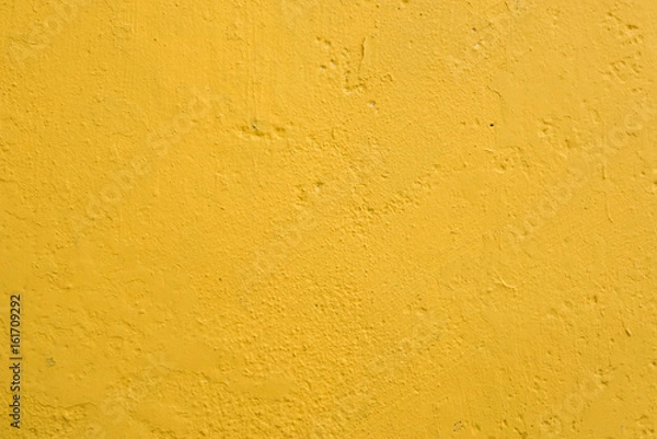 Fototapeta Close-up, full frame view a well-done light yellow wall texture background. Painted cement wall backdrop. Design element.