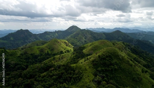 Obraz Lush green hills under cloudy sky