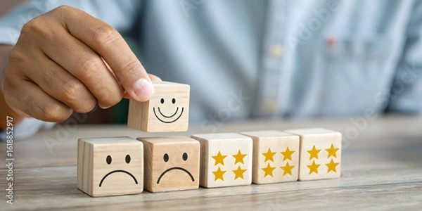 Fototapeta Hand placing happy face wooden block on row of blocks