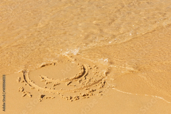 Obraz A painted smiley face on the beach sand