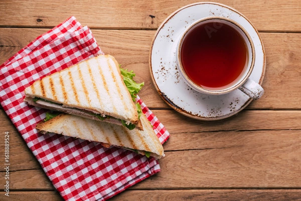 Obraz Sandwich and tea on wooden background