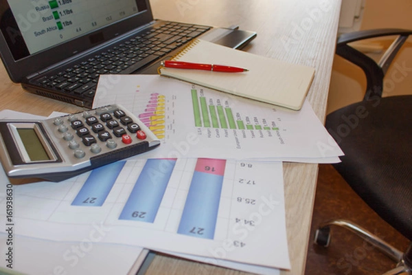 Fototapeta Graphs, charts, business table. The workplace of business people