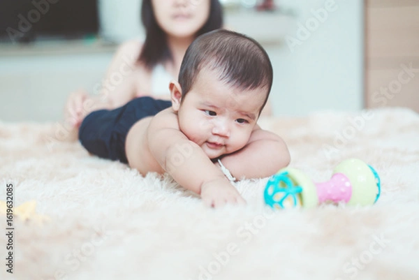 Obraz Happy adorable asian baby boy relaxing with mom on bed,Newborn child,Tummy Time