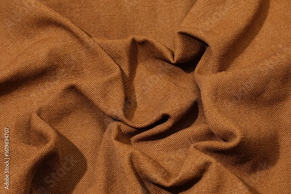 Obraz Brown fabric background. Selective focus. Brown cloth waves background texture.