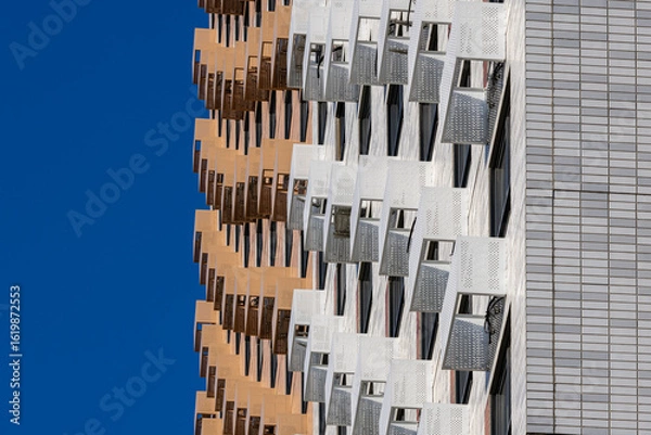 Fototapeta Baskets for placing outdoor air conditioner units on the facade of a new multi-story residential building. Climate control system in a residential building