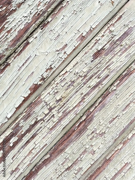 Fototapeta Closeup of diagonal wooden boards with peeling white paint abstract background texture