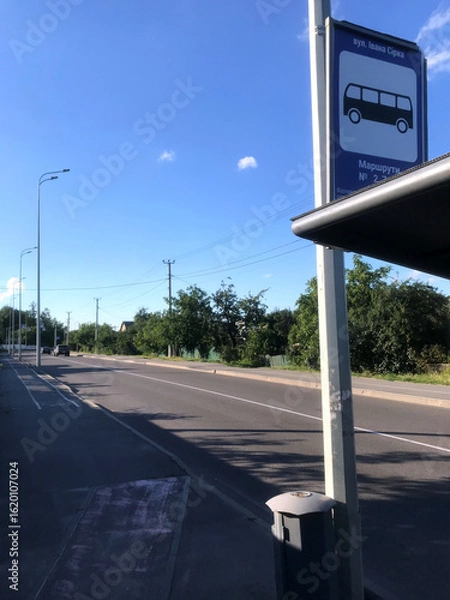 Fototapeta Quiet bus stop on a sunny day in a rural area