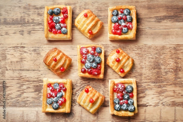 Obraz Delicious pastries with berries on wooden table