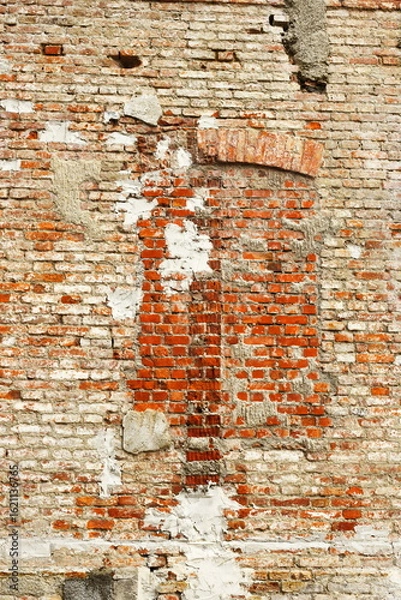 Fototapeta Old brick wall texture, weathered red bricks, rustic surface, exposed mortar, uneven brickwork, chipped and crumbling areas, historic building facade, vintage construction, urban decay aesthetic, arch
