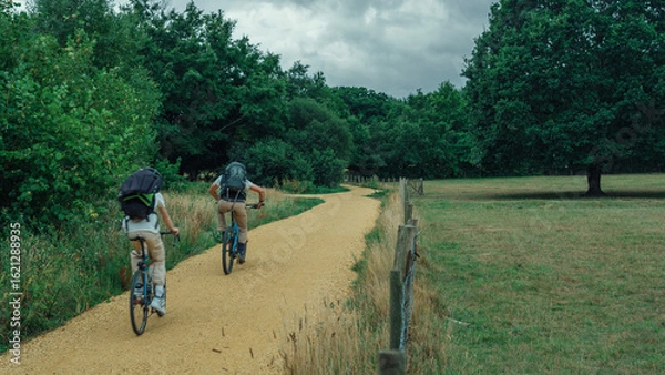 Obraz Cyclist Riding on an Open Road in Scenic Countryside