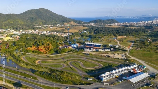 Obraz Drone view of Beto Carrero World kart track and amusement park with coastal city in the background.