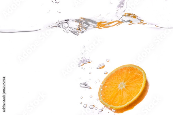 Obraz orange slice in water splash on white  background