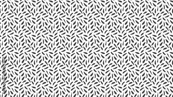 Fototapeta Seamless pattern of small black feathers scattered randomly on a white background creating a dense texture