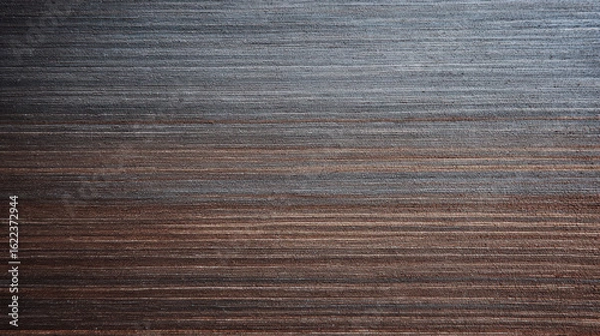 Fototapeta The horizontal lines in this wood grain background showcase a gradient transition from darker tones on the bottom to lighter, gray hues near the top surface here.