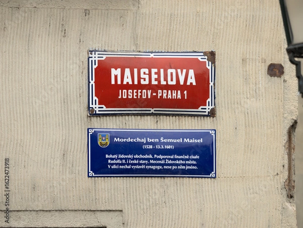 Fototapeta Maiselova street sign in Josefov Praha 1 in Prague, Czechia. Red colored road signage of the location in the so called Jewish Town. Information about the person Mordechaj ben Šemuel Maisel.
