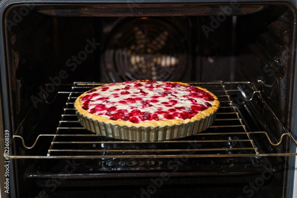 Fototapeta Closeup homemade cherry berry pie baked in a home oven. Shallow focus.