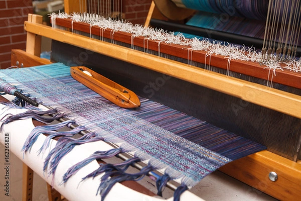 Obraz Weaving shuttle on the warp in weaving machine