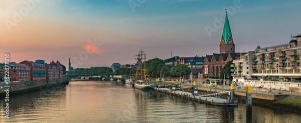Fototapeta Large panorama of the Weser river with the famous Schlachte embankment on the east bank in Bremen during sunset.