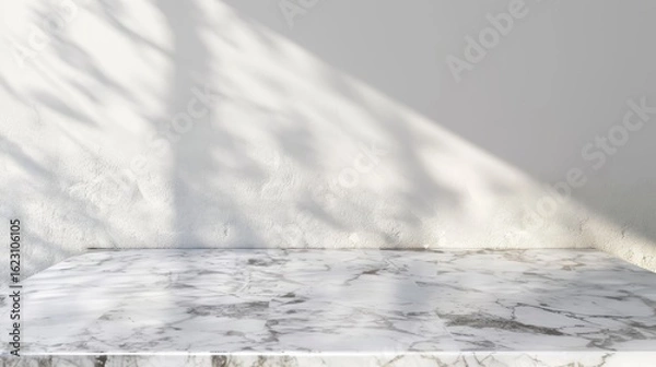 Fototapeta A marble surface with soft shadows against a light wall, creating a serene atmosphere.