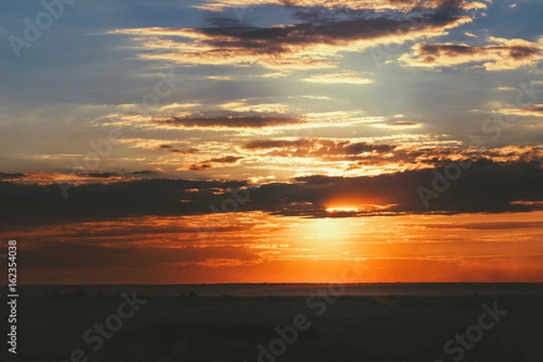 Fototapeta Great sunset in the field with clouds