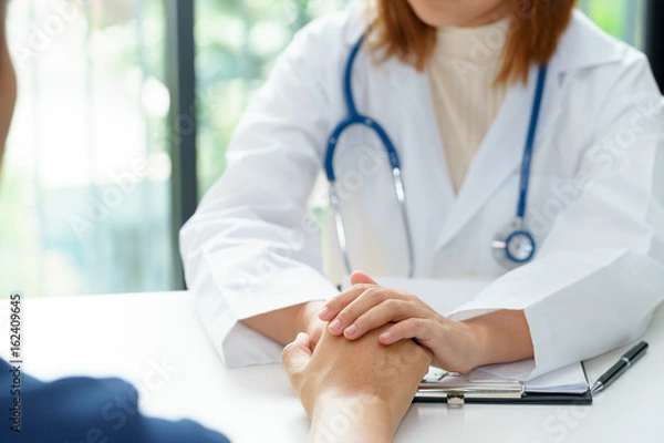 Obraz Female doctor holding patient hands for cheerful.