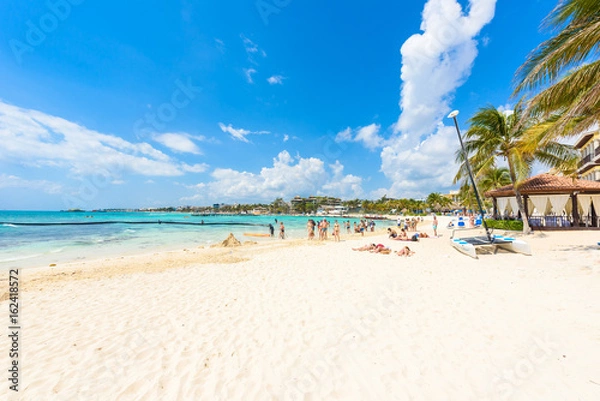 Obraz Playa del Carmen - relaxing on chair at paradise beach and city at caribbean coast of Quintana Roo, Mexico