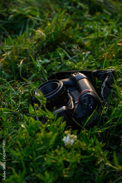 Fototapeta Mirror camera lying on grass, isolated photography equipment for realistic outdoor 3D presentation.