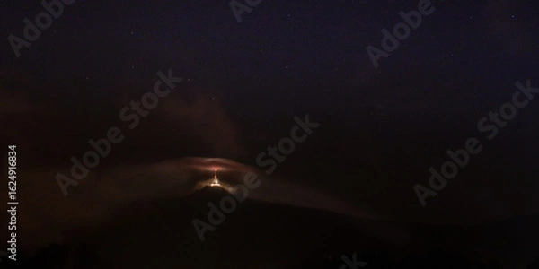 Fototapeta  night clouds over tower 
