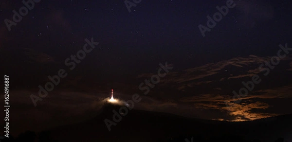 Fototapeta  night clouds over tower 