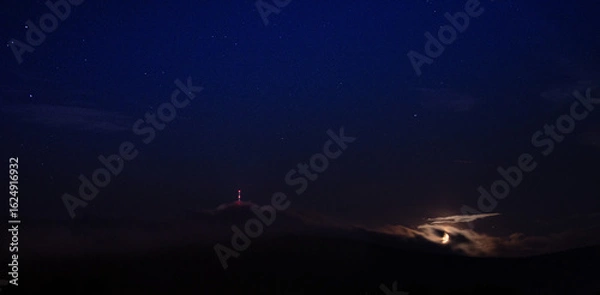 Fototapeta  night clouds over tower 