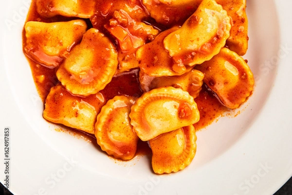 Fototapeta Ravioli beef tomato sauce second course fresh delicious gourmet food background on the table rustic food top view copy space