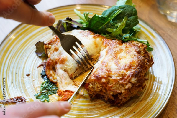 Obraz Cutting into crispy chicken parmigiana