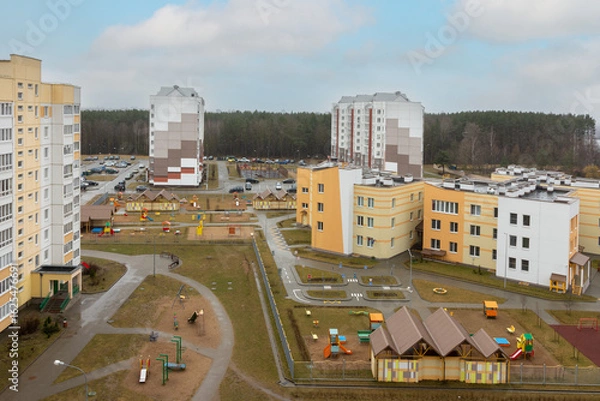 Fototapeta Aerial view urban housing complex with colorful playgrounds and multi-storey buildings