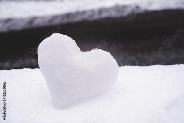 Fototapeta Heart of snow on white snow in winter, soft focus, close-up. Holiday valentine, romantic background.