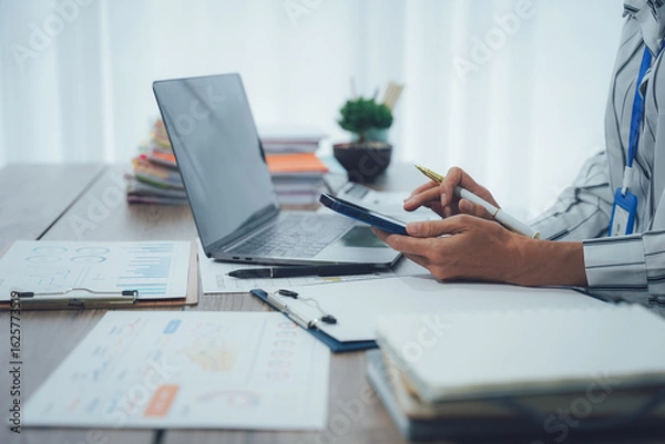 Obraz Two business people talk project strategy at office meeting room. Businessman discuss project planning with colleague at modern workplace while having conversation and advice on financial data report.