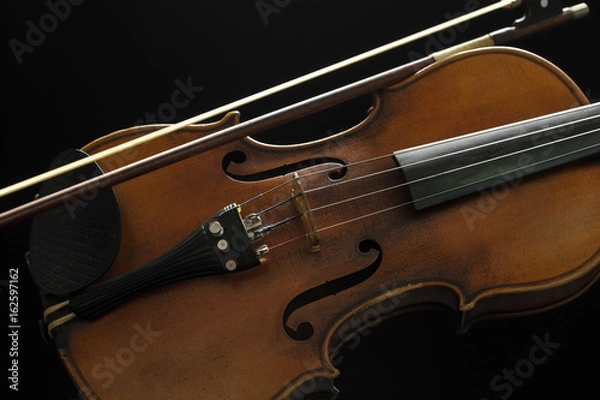 Fototapeta Old violin on a black background