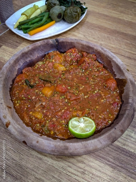 Obraz Sambal terasi is a traditional Indonesian chili paste made with chili peppers and terasi (fermented shrimp paste). It is one of the most popular types of sambal across Indonesia, known for its spicy, 