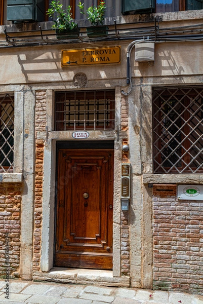 Fototapeta A photo of a building with a sign on the front of it