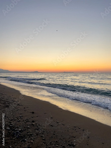 Obraz Sunrise colors stretch over the Cretan coastline. Concept of a calm, freedom, and the meditative stillness of early morning by the sea in Crete.