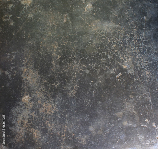 Obraz Cracked Dark Surface. Close-up of a dark cracked surface with fine web-like lines, evoking an aged or weathered appearance.