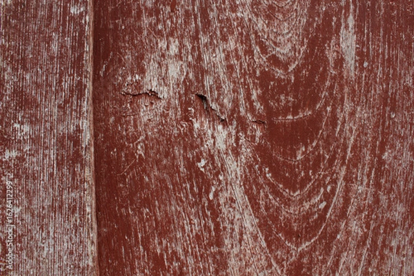 Obraz Cracked Red Painted Wood. Close-up of red painted wood with large cracks and weathered paint, showing deep texture and age.