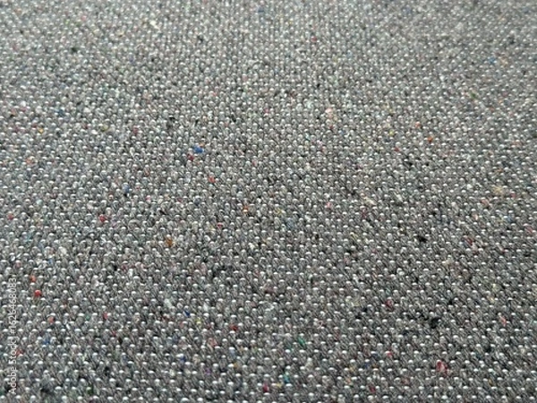 Fototapeta Close-up of dark fabric with tight weave and rich texture, perfect for t-shirt and clothing details. Deep tones and natural fibers background for fashion and textile design
